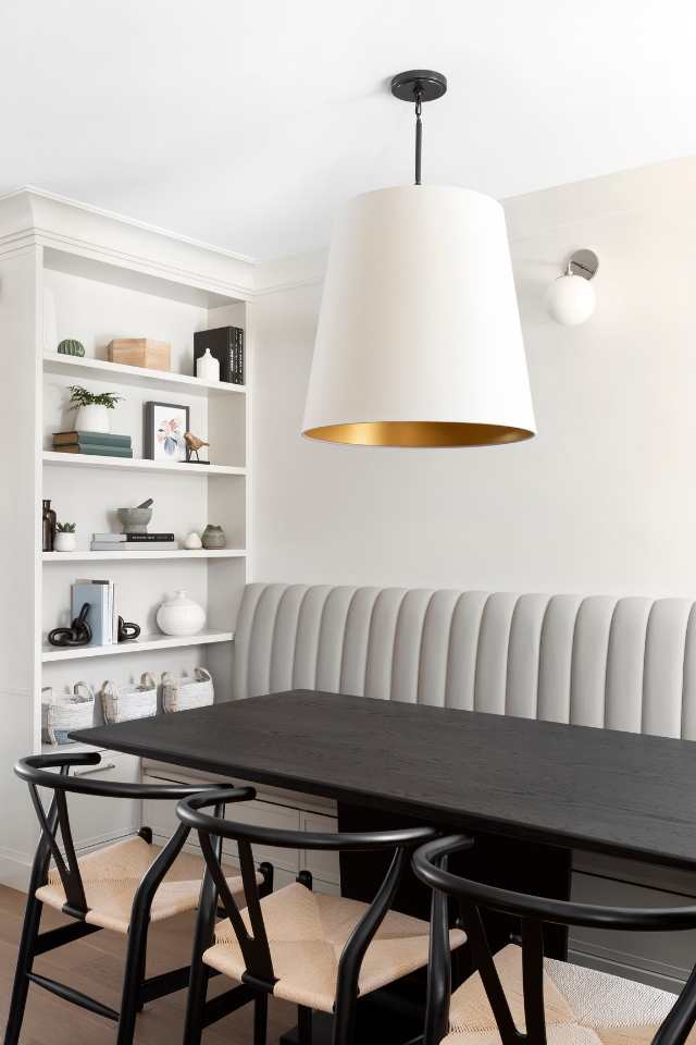 big white and brass pendant light over table in breakfast nook